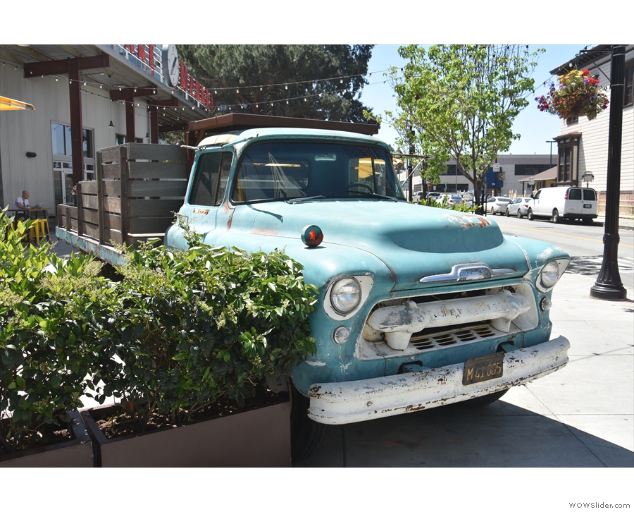 There's an old Chevy truck parked on the corner of San Pedro and Saint John Streets.
