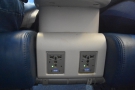 There's more power, a full international plug and another USB outlet, between the seats.