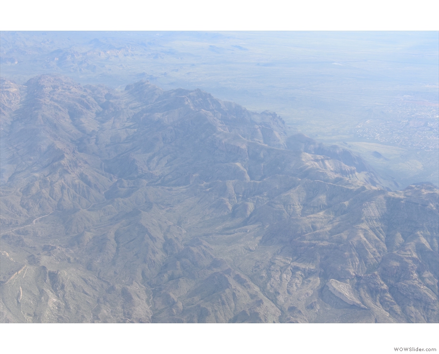 As we cross over to the Superstition Mountains, down below is the Apache Trail...