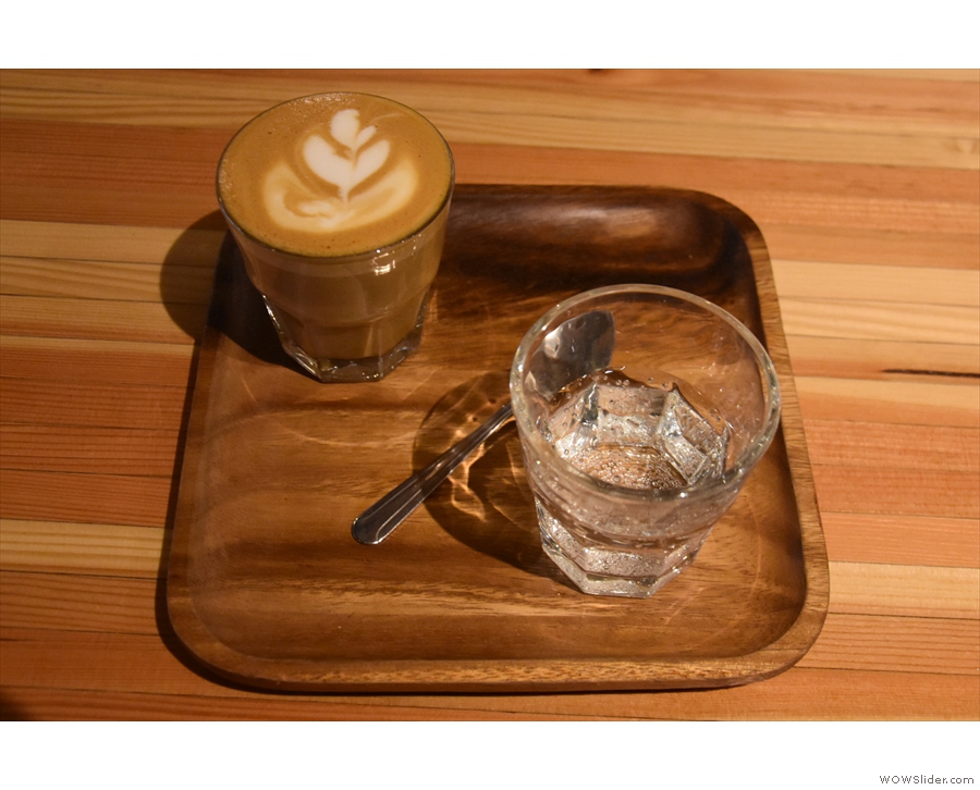 ... a cortado made with the Colombian single-origin espresso, served on a small wooden...