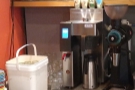 The batch brewer is against the wall behind the counter, along with its own EK43 grinder.