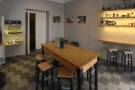 ... arranged around a central, six-person communal table. There's a short two-seat bar...