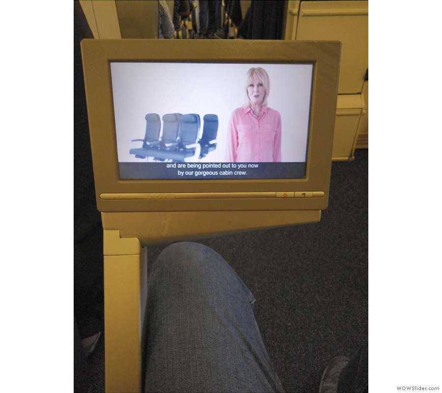 The TV screen lifts out from beneath the seat on an arm to one side.