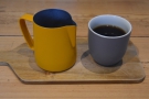 The poured coffee, with jug and cup presented on a wooden tray. We tried both the...