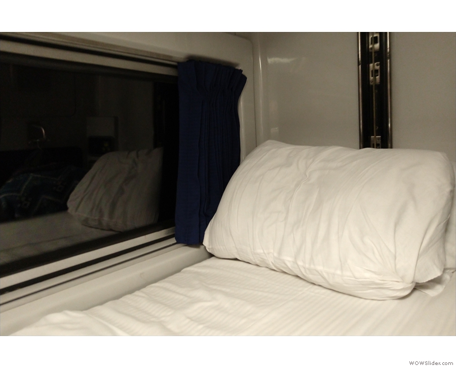 And here's the top bunk, which has its own window (which, in turn, has its own curtains)...