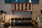... with a row of six grinders on the wall behind, one for each brew bar choice.