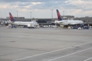 We stand on the tarmac, flanked by Delta planes on the adjacent terminal...
