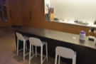 ... a row of three high-backed chairs tucked under an extension at the counter's far end.