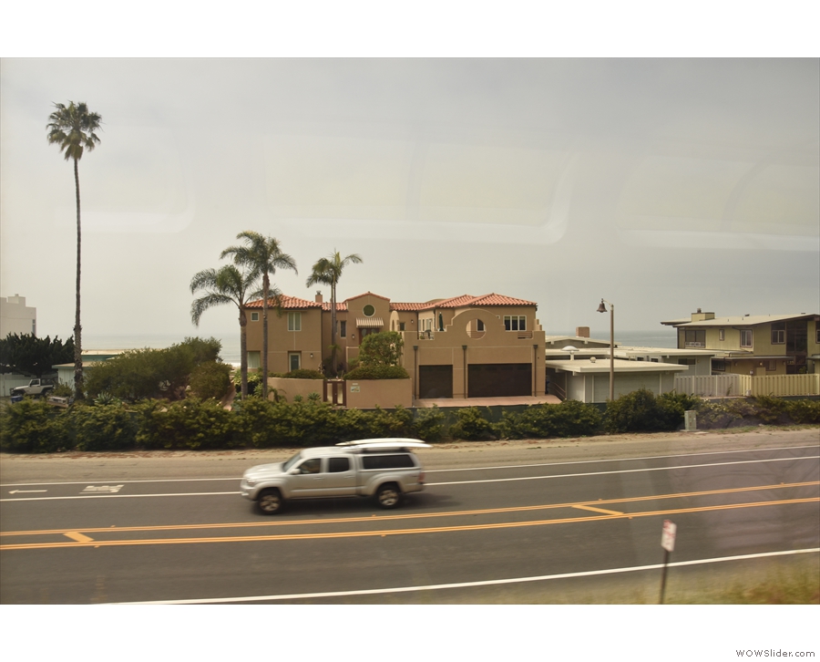 ... a linear collection of buildings between the road and the ocean.