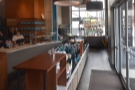 The doors open onto a row of retail shelves and a one-way system which leads to the...