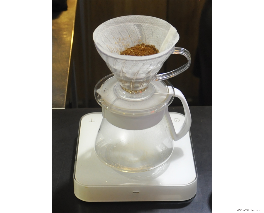 Next, put the ground coffee into the prepared filter paper. This is a pour-over which was...