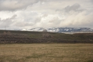 ... upland meadows, the high, snow-capped peaks of the Rockies in the distance.
