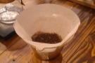 While the Chemex filter paper is much thicker, the grind is the same for both methods. As before, a precise amount of ground coffee is weighed out and put into the filter.