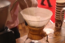 Unlike the pour-over, the water is weighed as it is poured to ensure a precise dose. However,  as before, a small amount is poured in first to allow the grounds to bloom. 