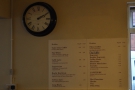 The interestingly located menu on the wall opposite the counter.