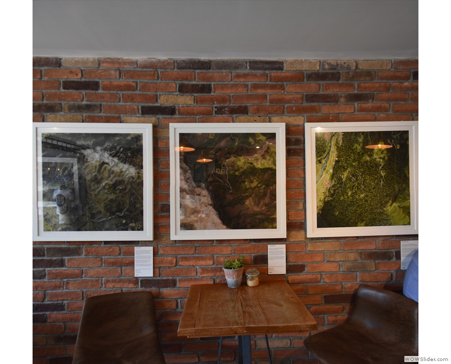 I liked the pictures hanging on the exposed brick wall behind the tables...