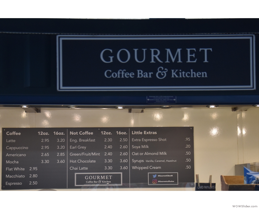 The menu, on the kiosk's back wall, is clearly visible through the newly-installed Perspex.
