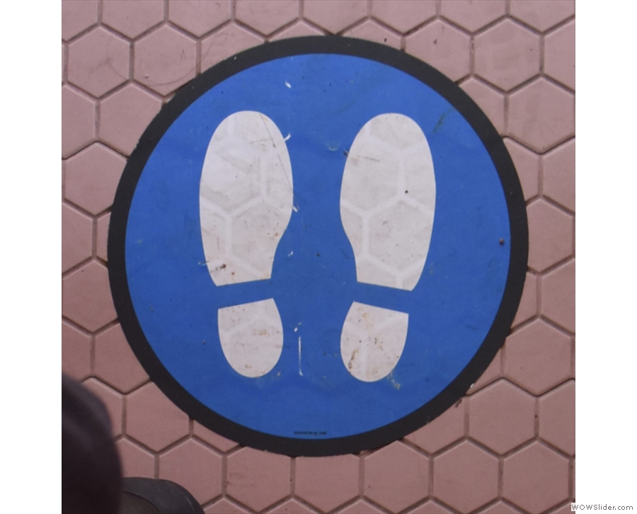 The handy footprints in blue circles show you where to stand if you need to queue.