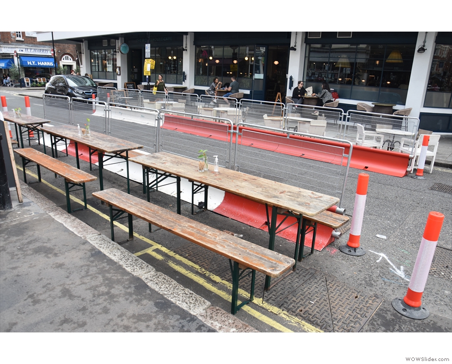... to add three long, thin tables with benches at the side of the road.