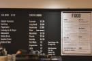 The tea, coffee and food menus are displayed on the wall behind the counter...