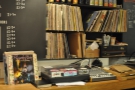 ... is a turntable, along with a library of vinyl records, source of the background music.
