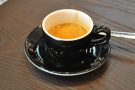 And the output: a great espresso in a classic black cup.