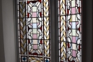 Even better, in a little alcove off to one side at the top of the stairs is this stained glass.