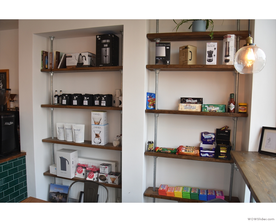 Carbon Kopi has a set of retail shelves built into the wall in front of the counter.