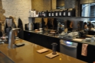The counter is sparsely populated. The brew bar, with its own grinder, is at the far end.