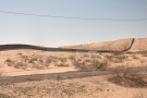 ... although by now the train is in New Mexico. That's the border wall with Mexico.