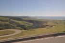 You can see the road as it climbs up the hill, with the coast to the south in the distance.