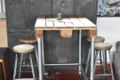 Opposite it, against the right-hand wall, is this high, four-person table...