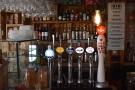 There's a selection of beer on tap, with spirits on the shelves behind...