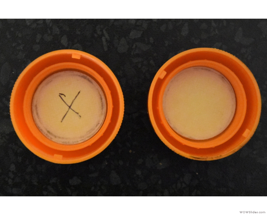 Identical, that is, apart from a mark on the inside of the lids.