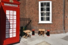 If you want a seat, two small tables (each with a stool) lurk behind the telephone box.