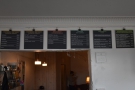 The food and drink menus are on the wall behind/above the counter...