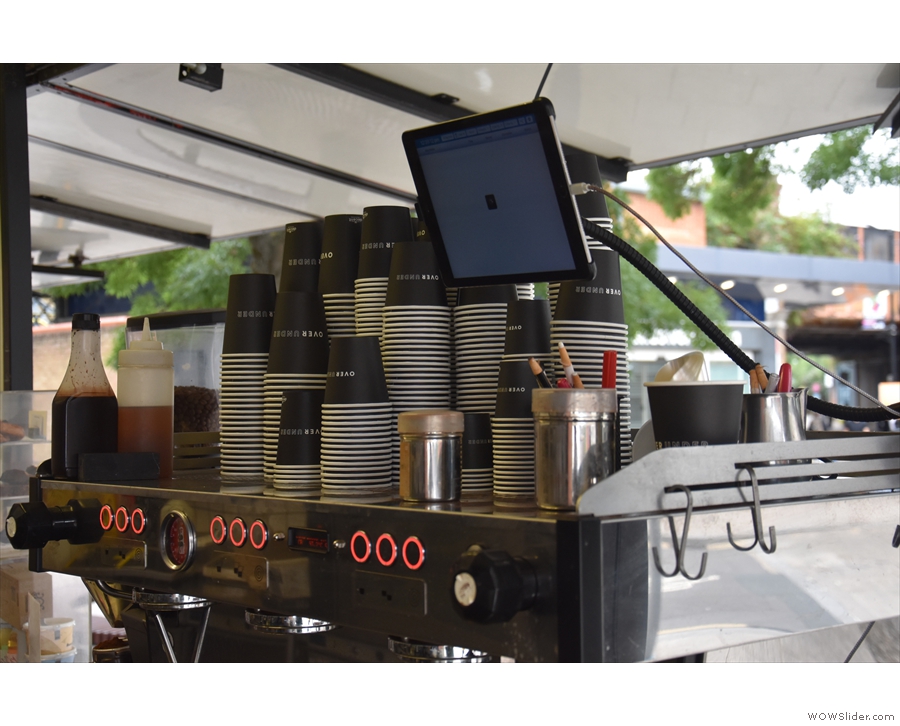 Shots are pulled on this three-group La Marzocco (the tablet is for app/delivery orders).