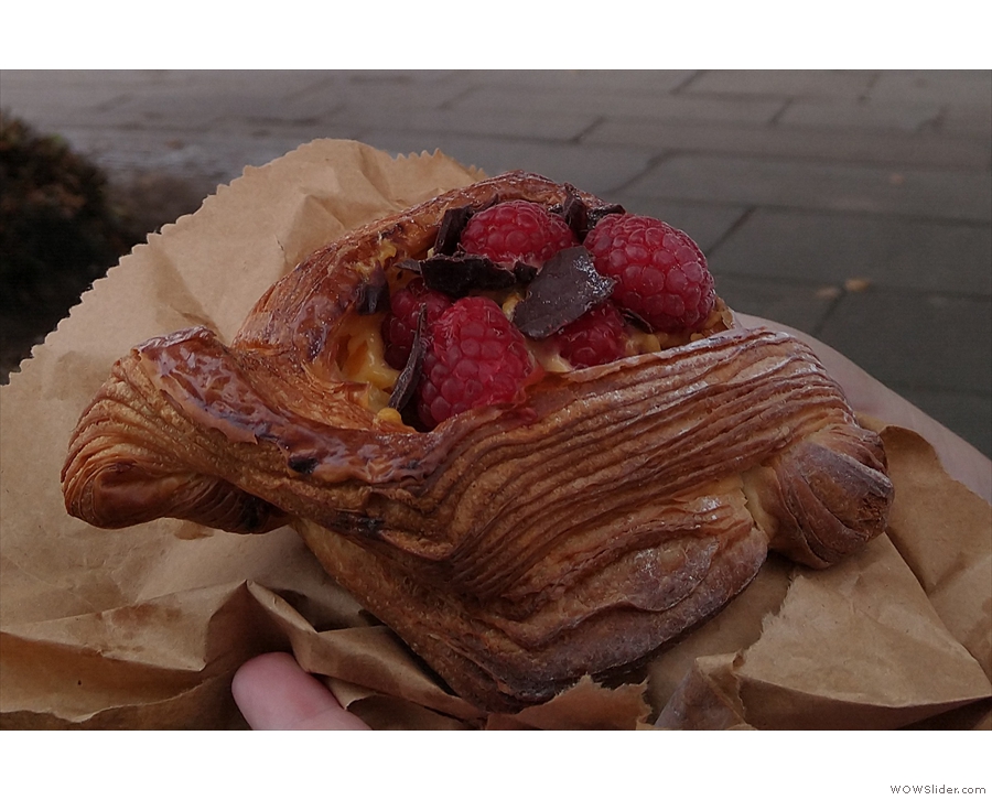 The raspberry Danish, topped with fresh raspberries and chocolate shavings, in more detail.