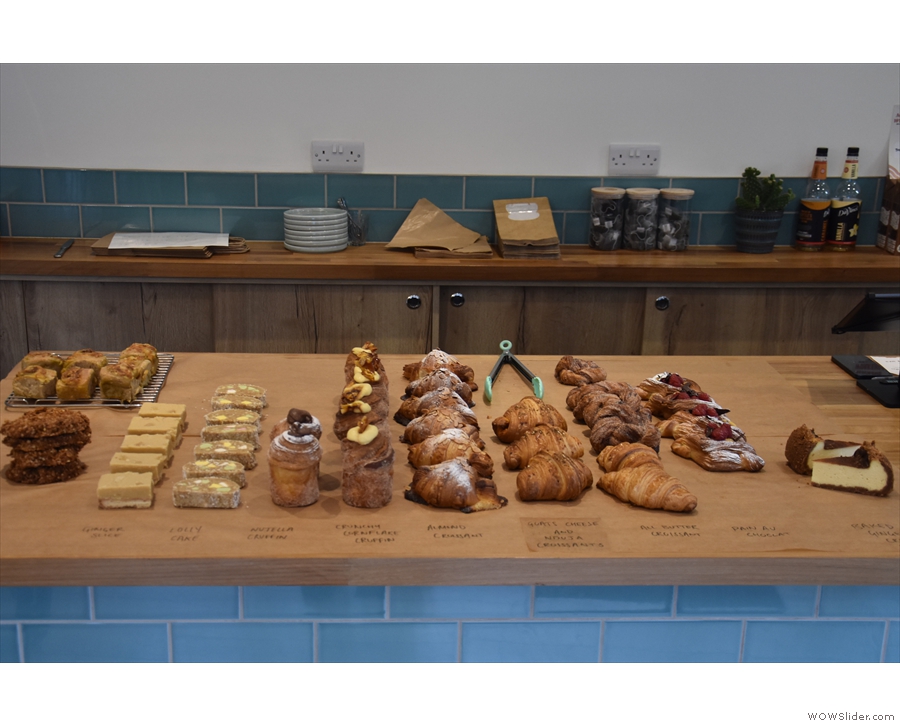 The day's baking is on the left: cakes, biscuits, pastries and some savouries are on display.