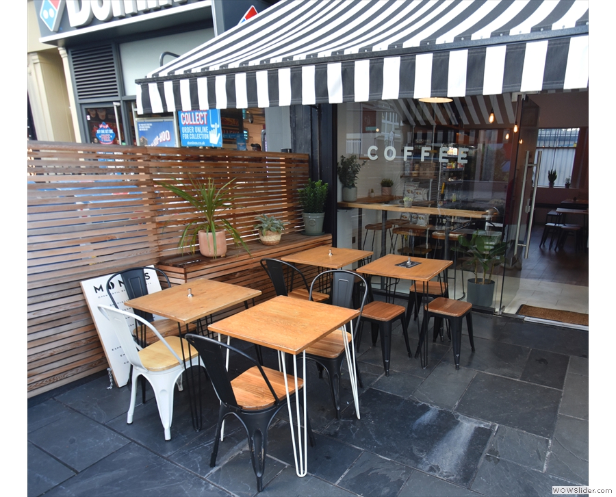 The large, outdoor seating terrace has tables on the left...