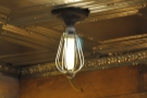 ... a bare bulb hangs from the tin ceiling.