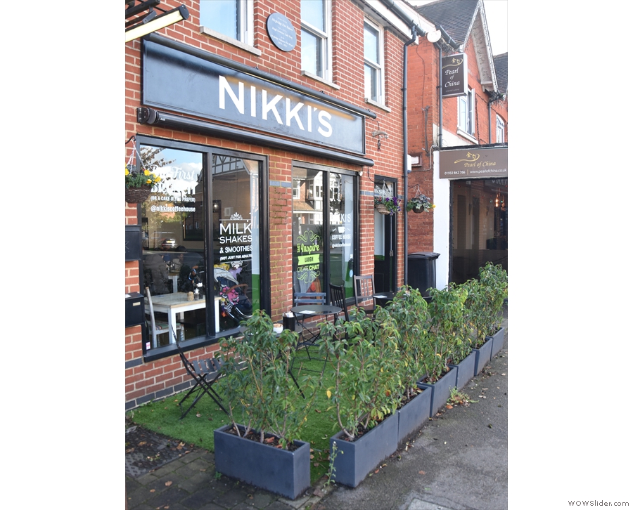There's a small, outdoor seating area in front of Nikki's, delineated by these low planters.