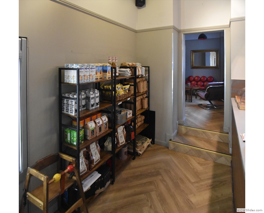 ... with the retail shelves on the opposite wall of the narrow, middle room.