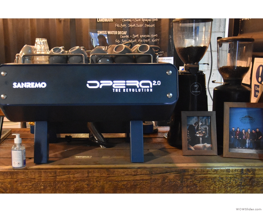 ... with the Sanremo Opera 2.0 espresso machine and its grinders to the right.