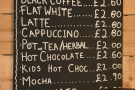 The concise coffee mneu is on the back wall behind the counter...