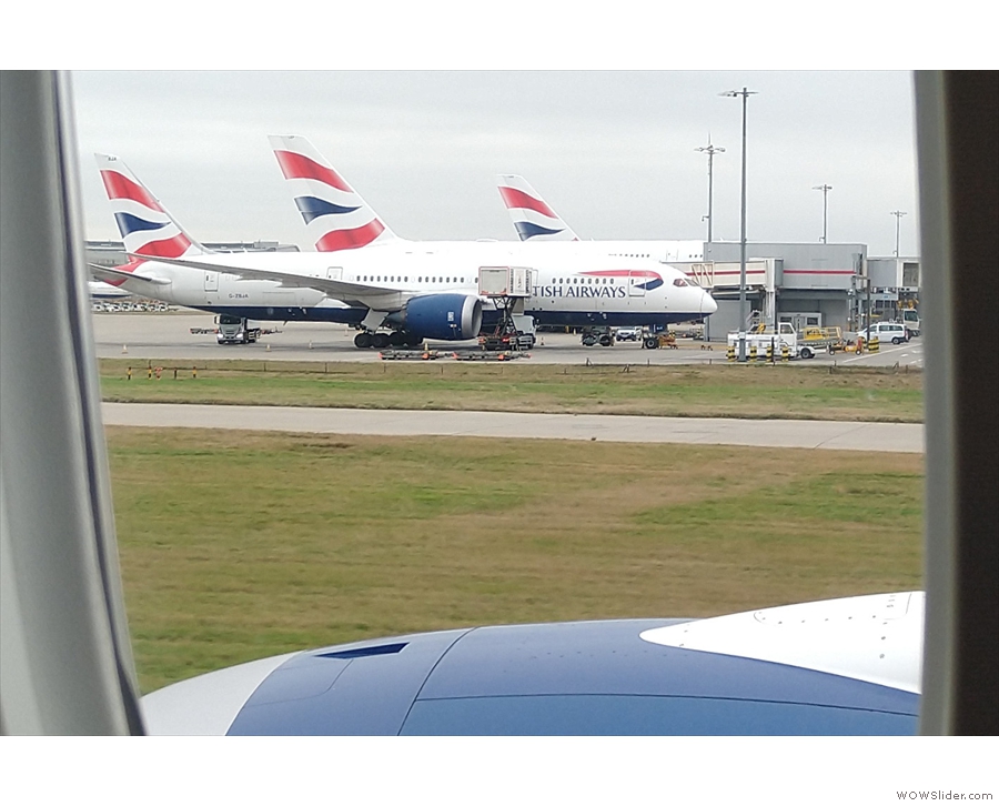 More British Airways jets, a smaller A319/320/321, with a larger one behind it.