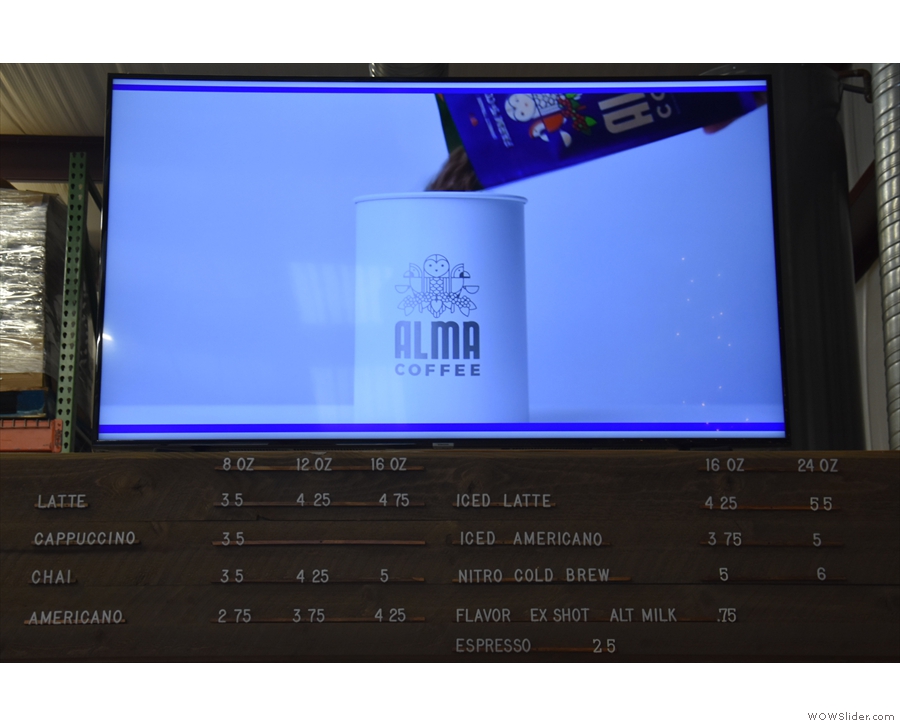 The (very concise) menu is above the counter, below a large advertising screen.