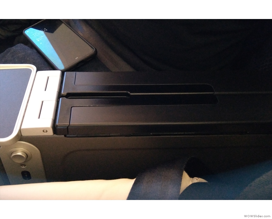 The remaining photos are from the 787. The shared armrest to the right holds the...