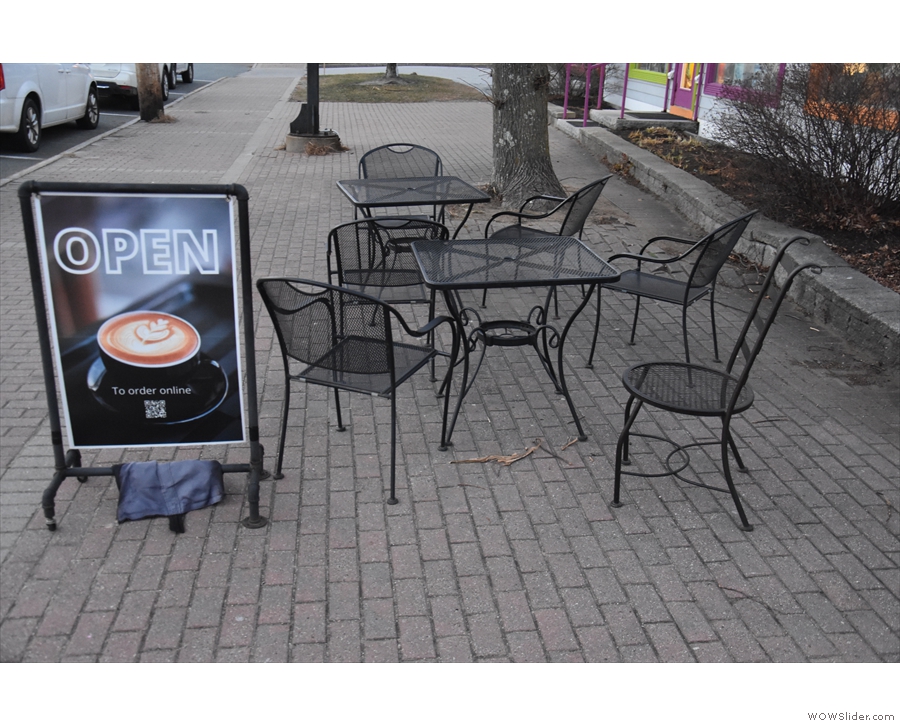 ... while to your left are a pair of tables on the broad pavement (sidewalk). However...