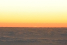 Is that the very tip of the setting sun, just visible above the clouds?